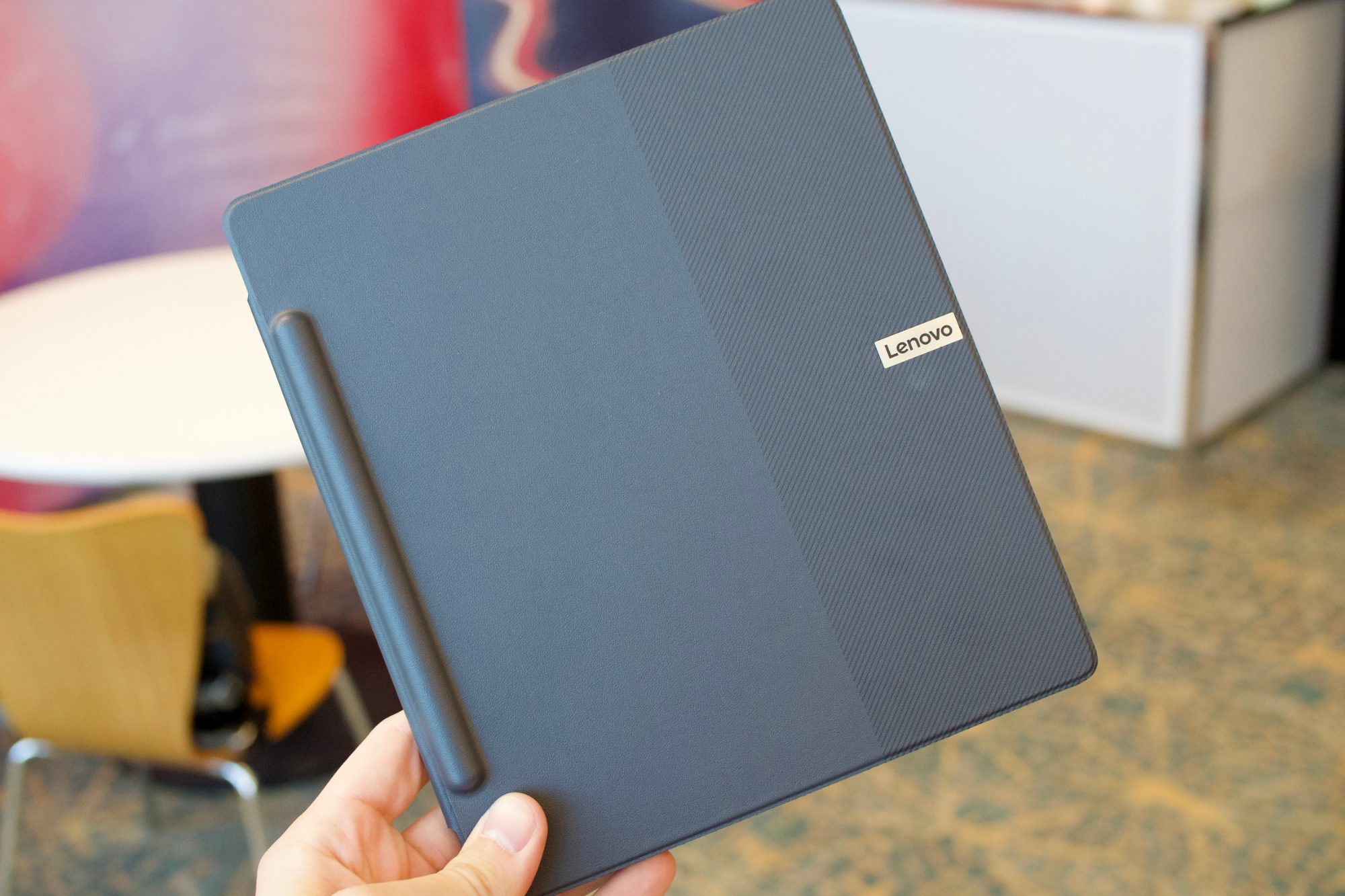 Holding the Lenovo Smart Paper.
