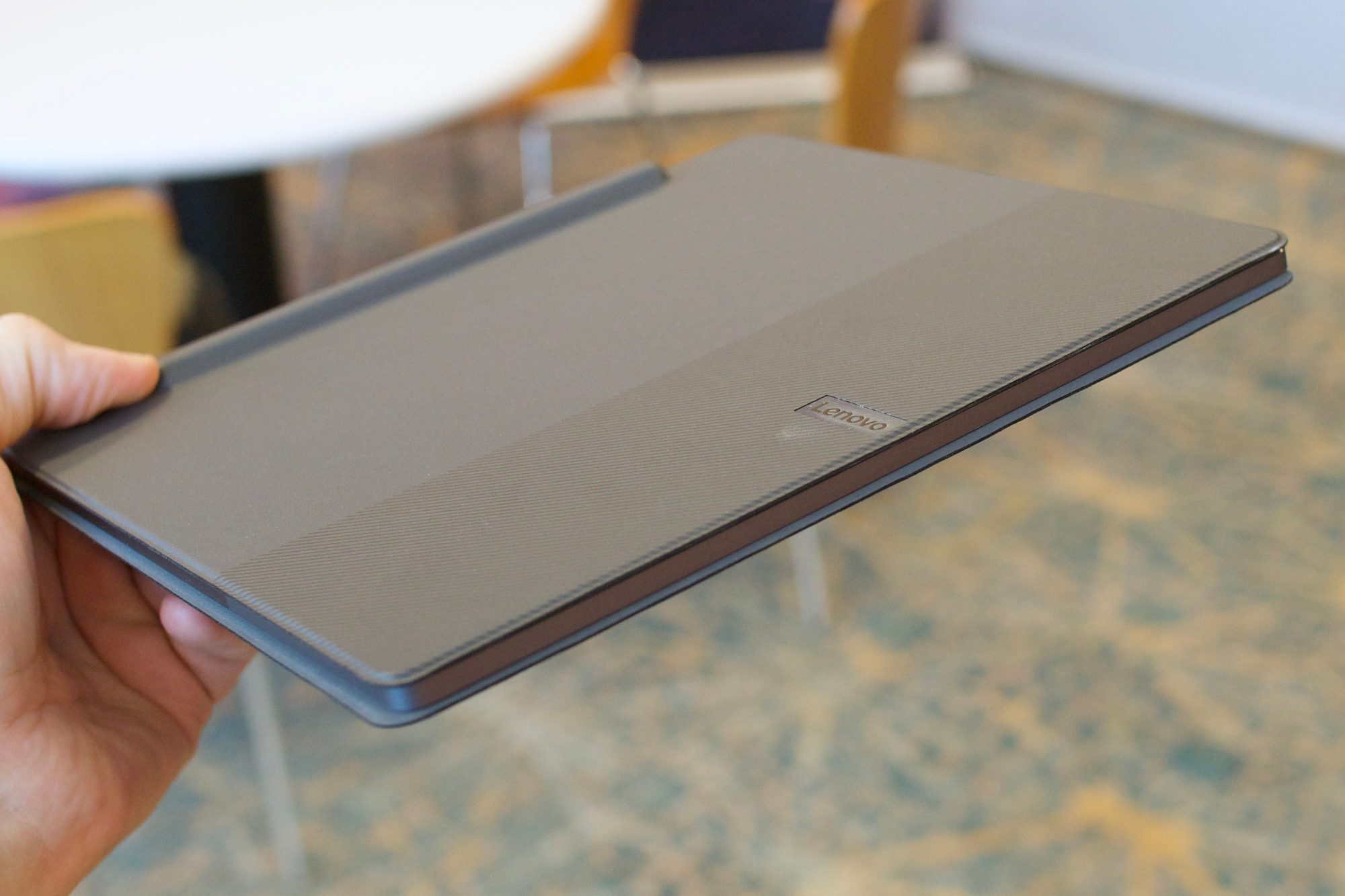 Holding the Lenovo Smart Paper.