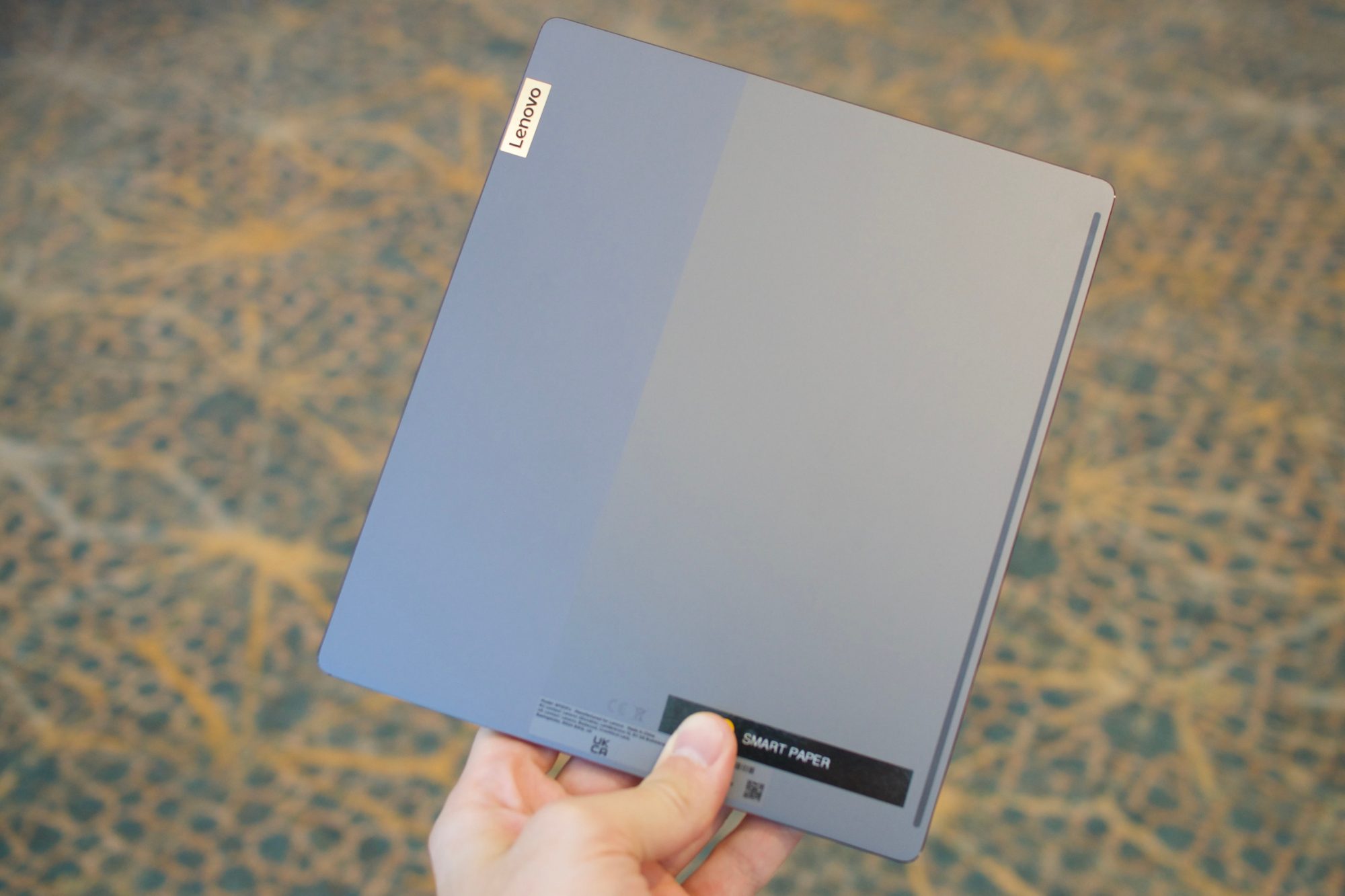 Holding the Lenovo Smart Paper.