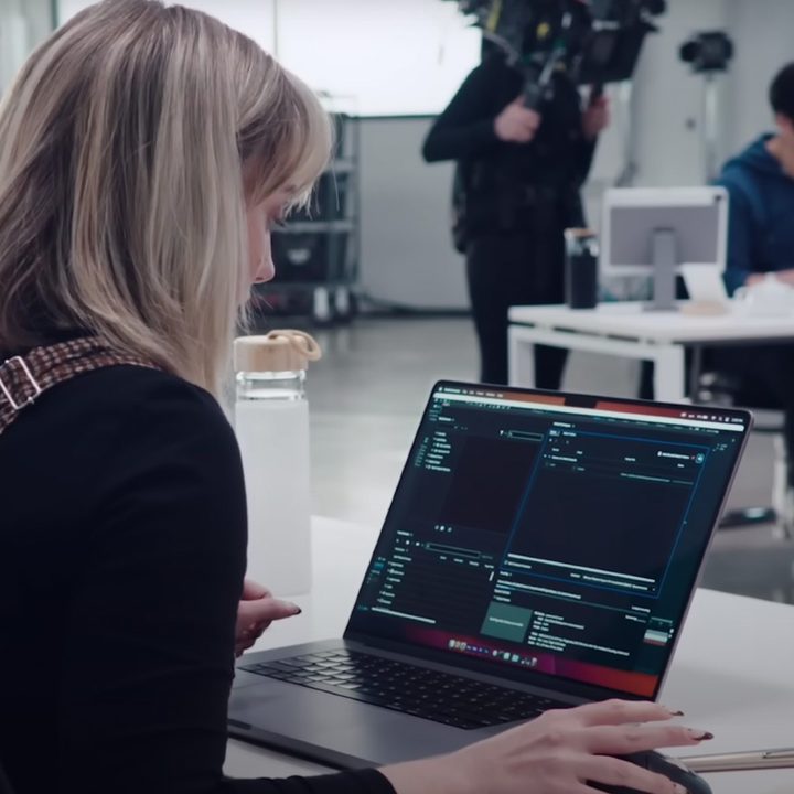 A woman using a MacBook Pro in a studio.