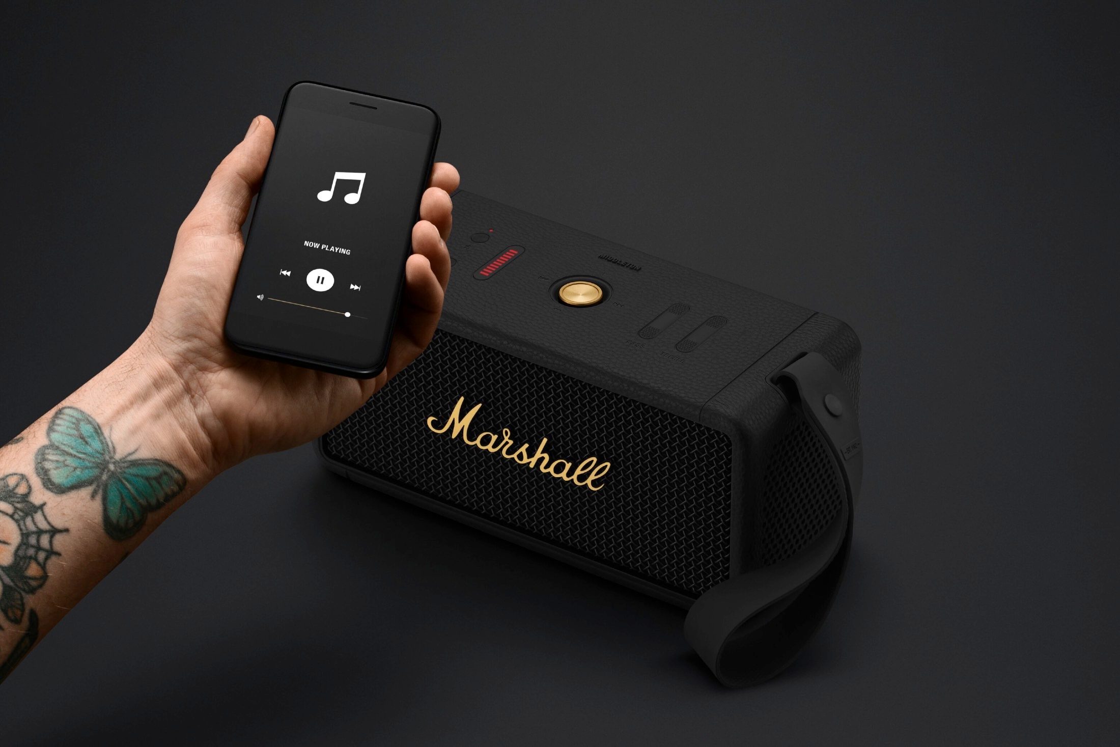 Hand with smartphone in front of Marshall Middleton.