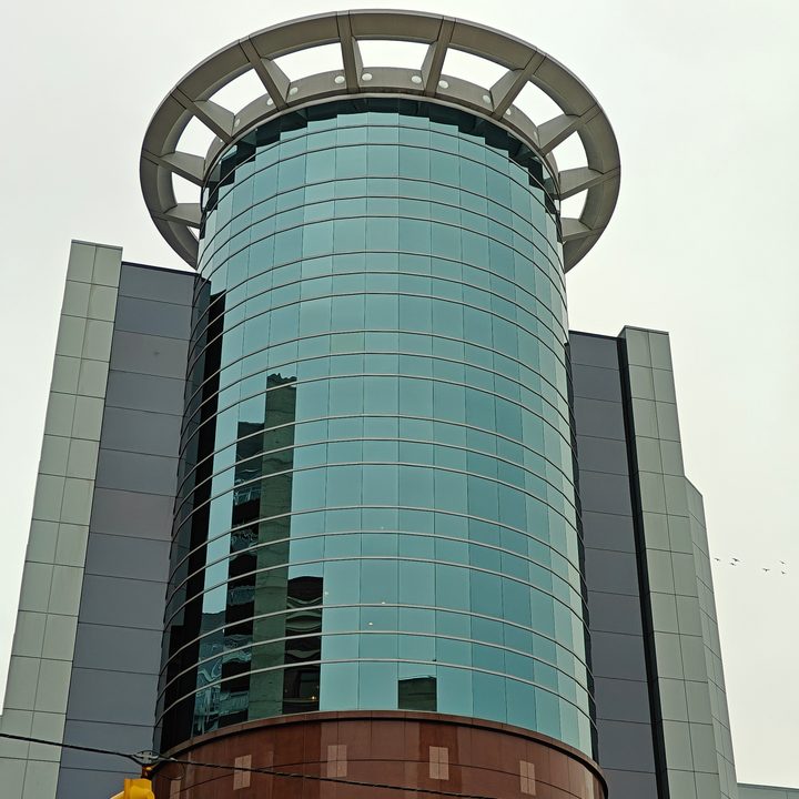 Zoomed in photo of a circular, glass building.