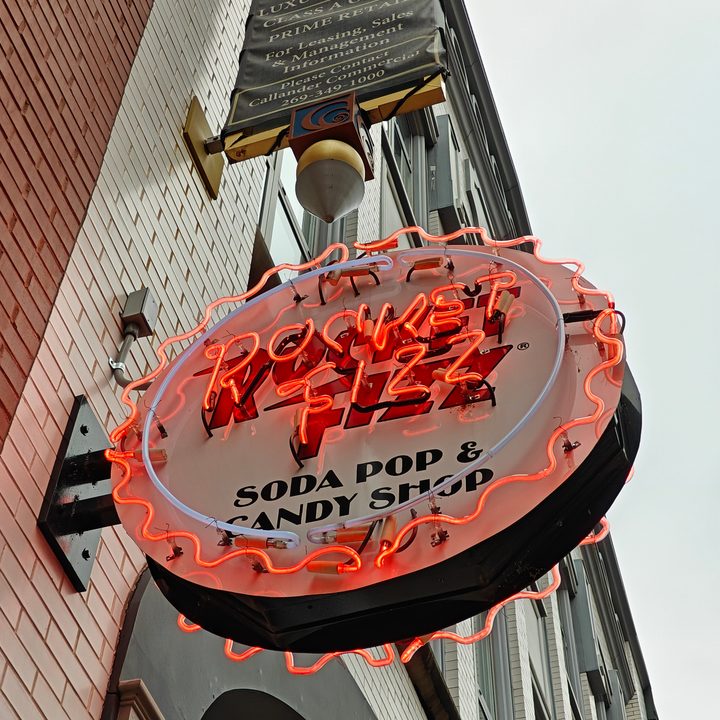 Photo of a neon sign for a soda shop.
