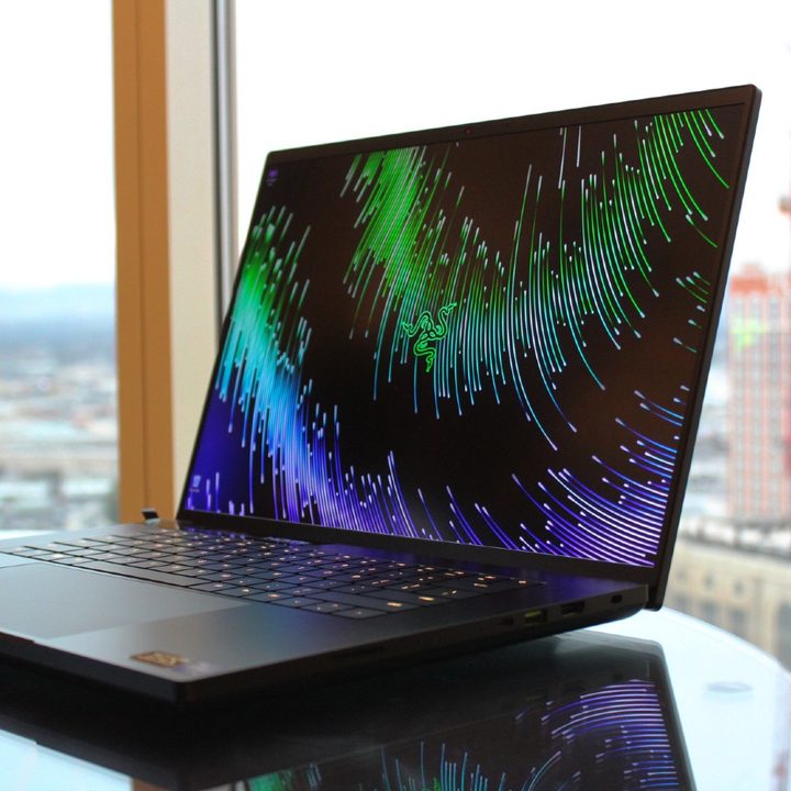 The Razer Blade 18 on a table in front of a window.