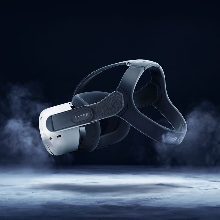A Meta Quest 2 floats in the air with Razer accessories attached to it.