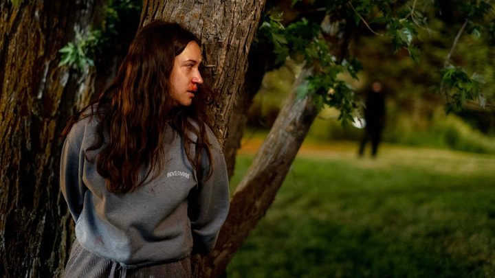 A girl hides from a killer in Sick.