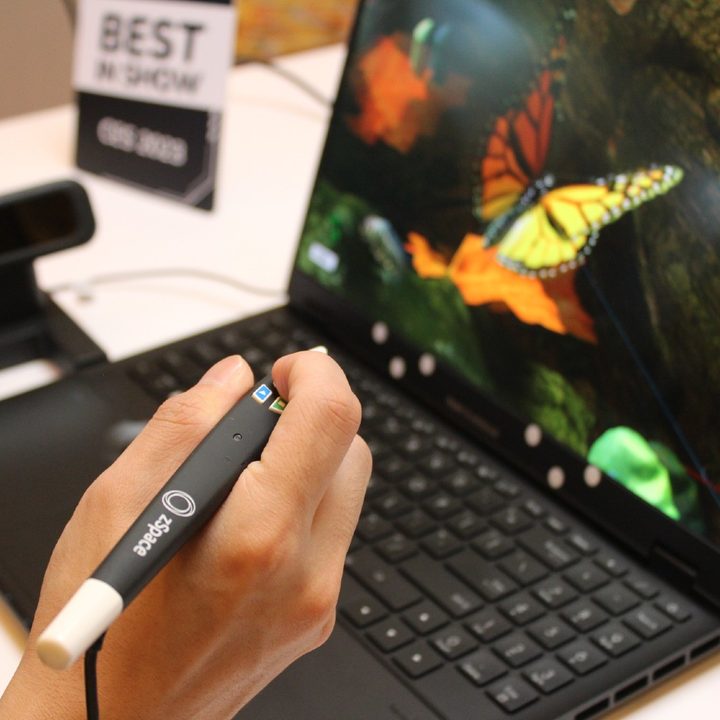 The zSpace stylus being used with the 3D screen on the ProArt Studiobook laptop.