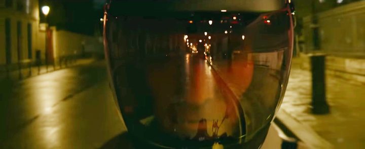 A man in a helmet rides at night in Netflix's The Killer.