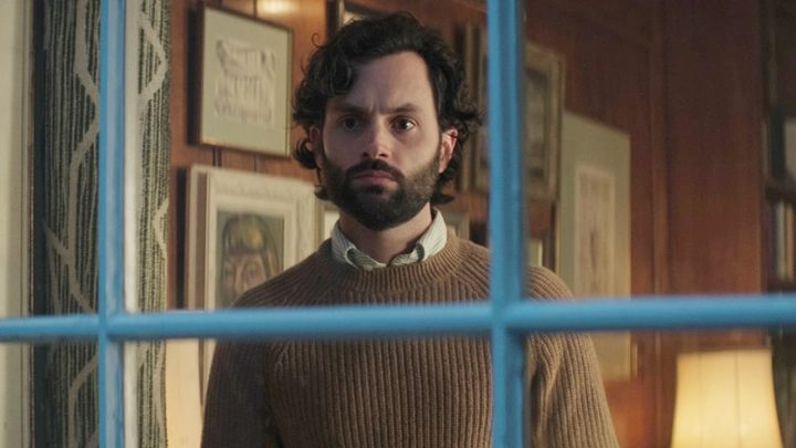 Joe looks out of a window in You season 4.