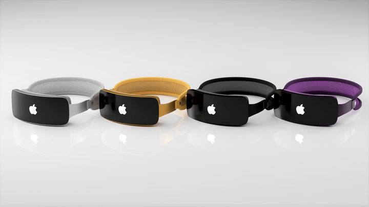 A rendering of four Apple mixed-reality headsets (Reality Pro) in various colors sitting on a surface.