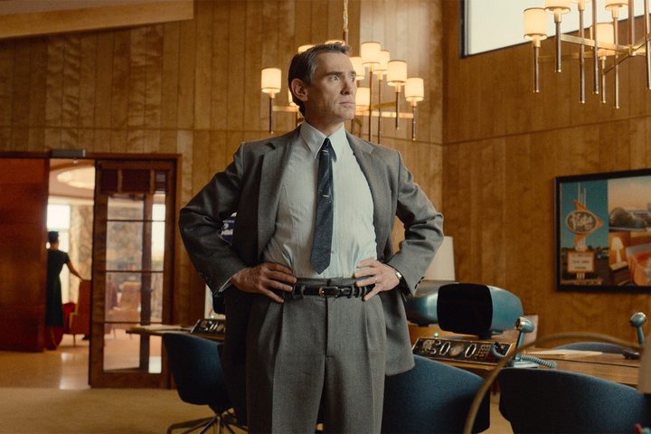 Billy Crudup stands with his hands on his hips in Hello Tomorrow.