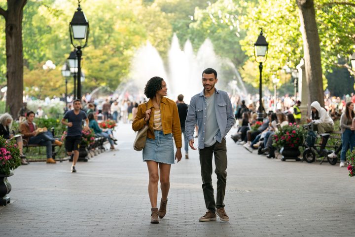 Briana Middleton and Justice Smith walk through a park together in Sharper.