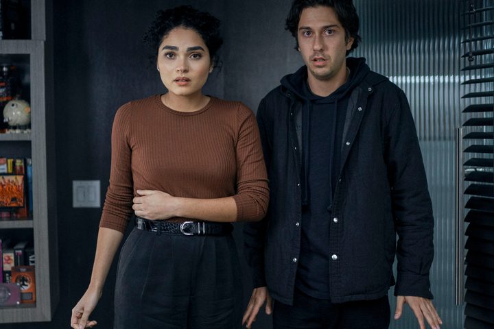 Brittany O'Grady and Nat Wolff stand in an office together in The Consultant.