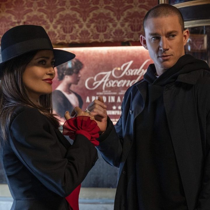 Channing Tatum and Salma Hayek stand in a theatre lobby together in Magic Mike's Last Dance.