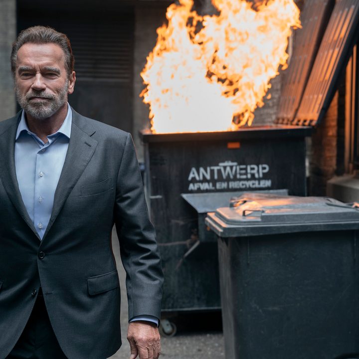 Arnold Schwarzenegger walks away from a dumpster on fire in Fubar.