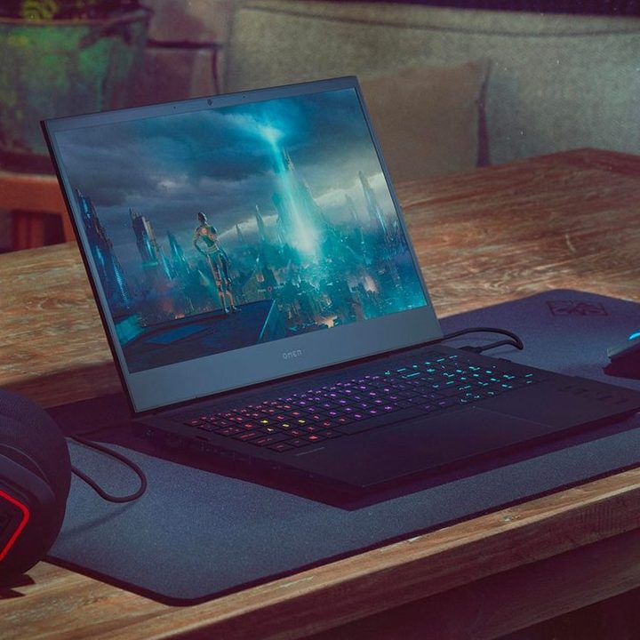 The HP Omen 16-inch gaming laptop on a desk with gameplay action on the screen.