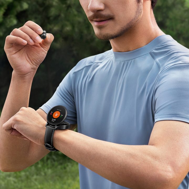 Person using the Huawei Watch Buds, with the smartwatch open on the wrist.