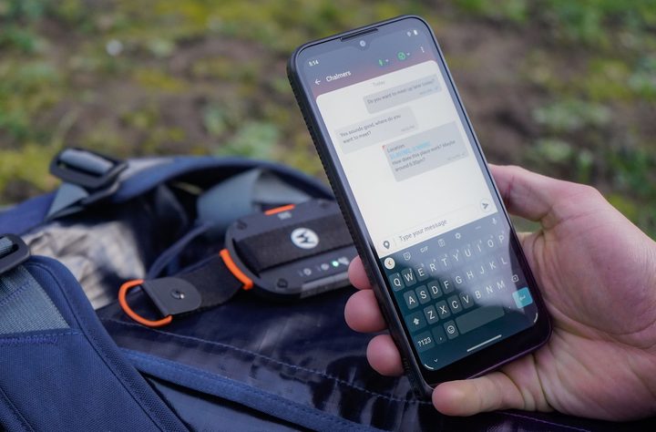 The Motorola Defy Satellite Link dongle being used with a smartphone.