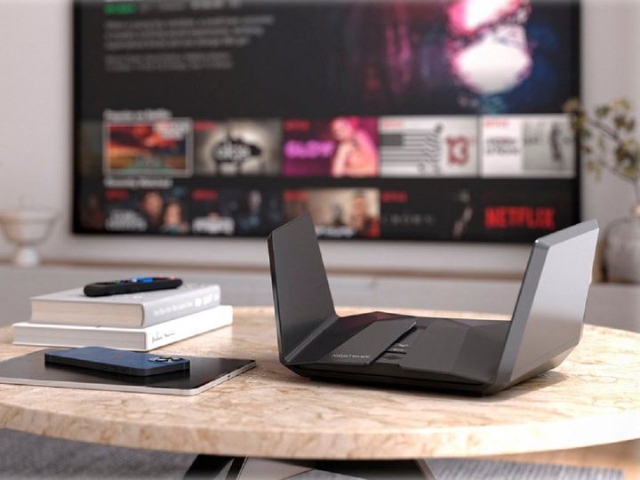 The Netgear Nighthawk AXE11000 Tri-Band Wi-Fi 6E Router on a table.