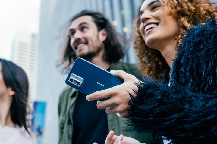 The Nokia G22 held in a person's hand.