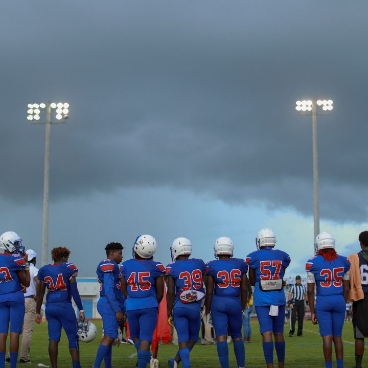 A football team lines up on the sidelines from Outta the Muck.