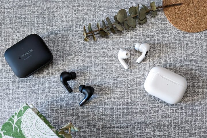 OnePlus Buds Pro 2 in black and AirPods Pro first generation in in white on a white and gray table top.