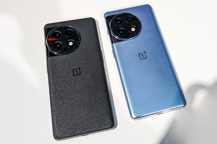 OnePlus 11R in gray black and silver blue colors on a white table top.