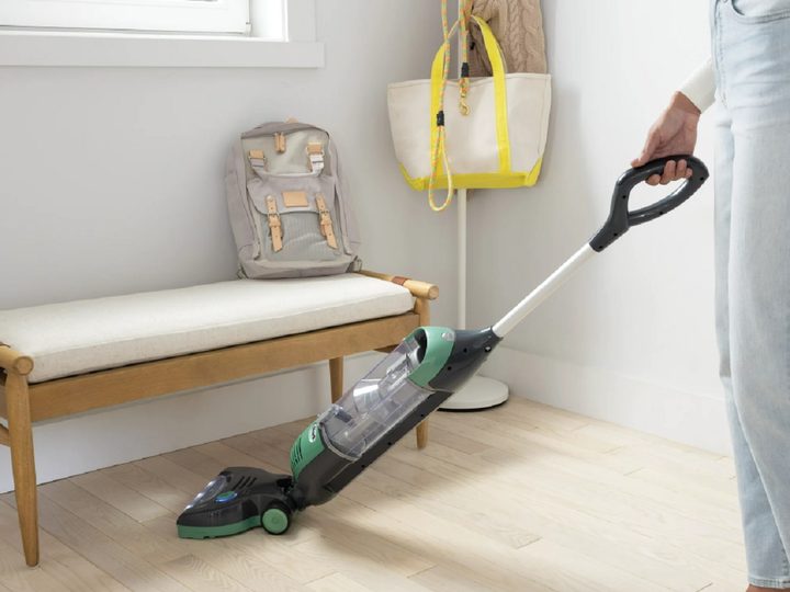 The Shark Freestyle Pro cordless vacuum, cleaning under a bench.