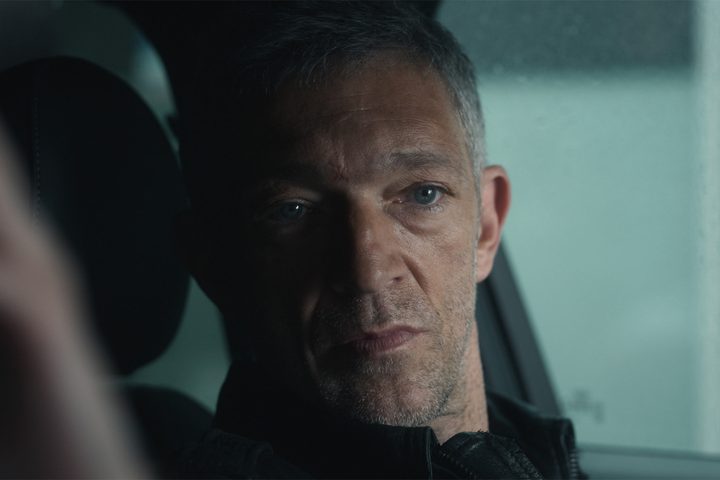 Vincent Cassel sits in a car in Liaison.