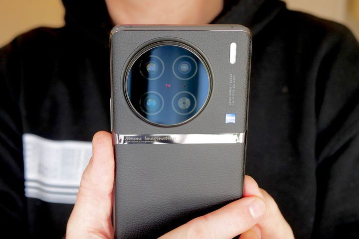 The Vivo X90 Pro held in a person's hand.