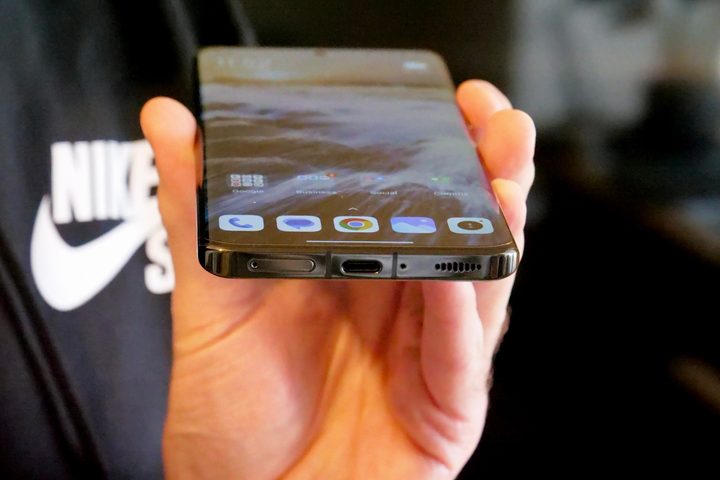 The base of the Xiaomi 13 Pro, held in a person's hand.
