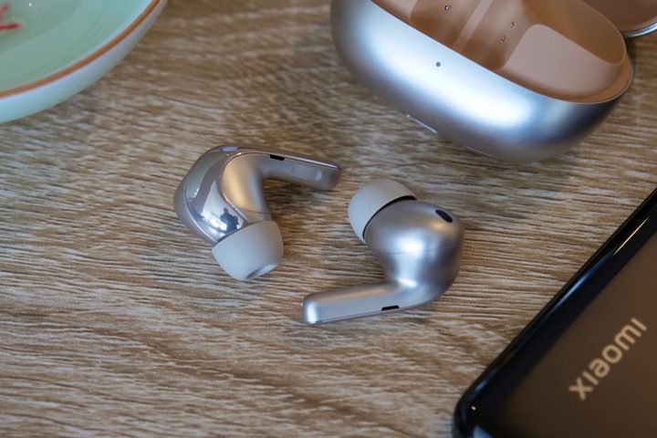 The Xiaomi Buds 4 Pro earbuds on a desk.