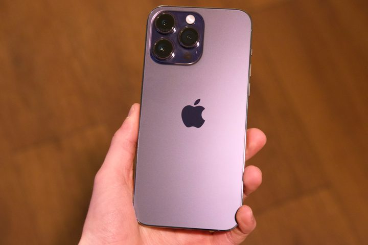 Someone holding a purple iPhone 14 Pro Max.