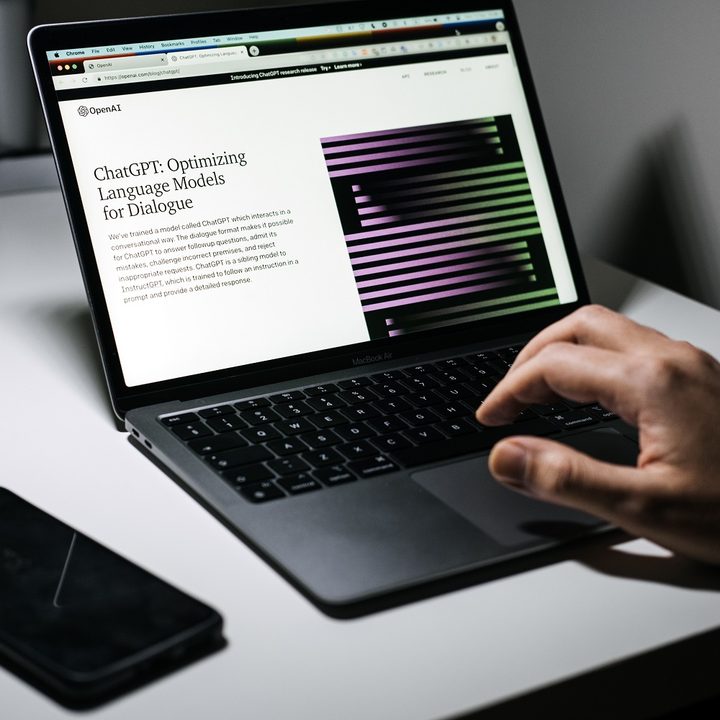 A laptop opened to the ChatGPT website.