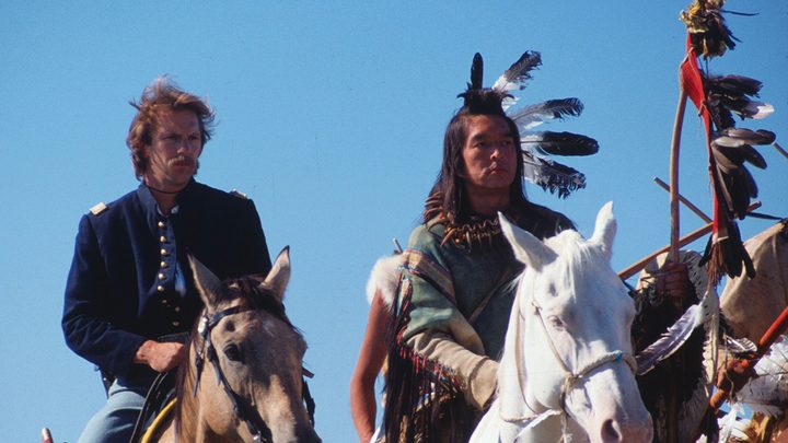 Two men riding horses in a scene from Dances With Wolves.