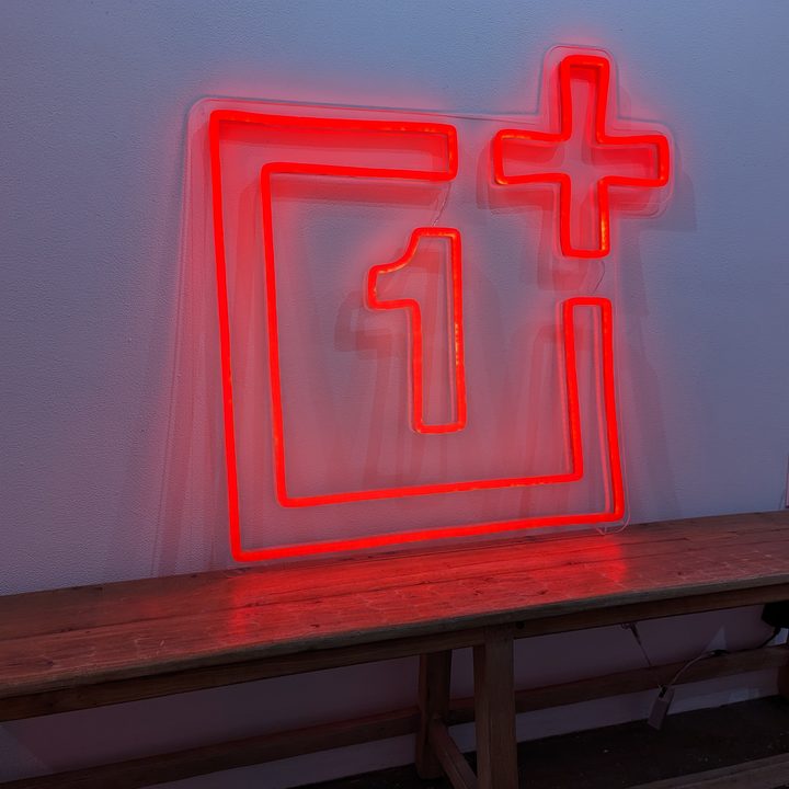 Pixel 7 Pro photo of a red neon sign of the OnePlus logo.