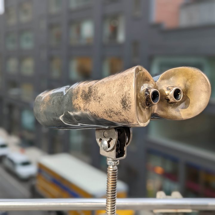 Pixel 7 Pro portrait mode photo of binoculars looking at downtown Chelsea.
