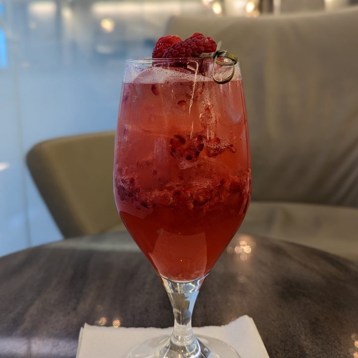 Pixel 7 Pro portrait mode photo of a raspberry drink on a table.