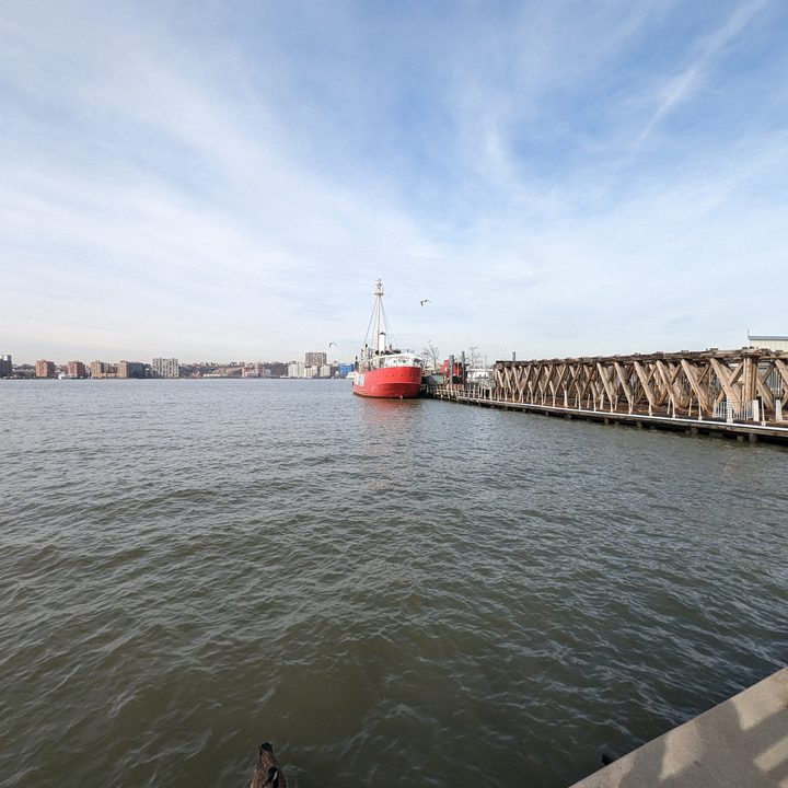 Wide-angle photo from the Pixel 7 Pro, showing a red boat by a dock on the water.