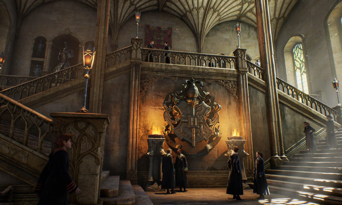 Students stand around a lobby in Hogwarts Legacy.