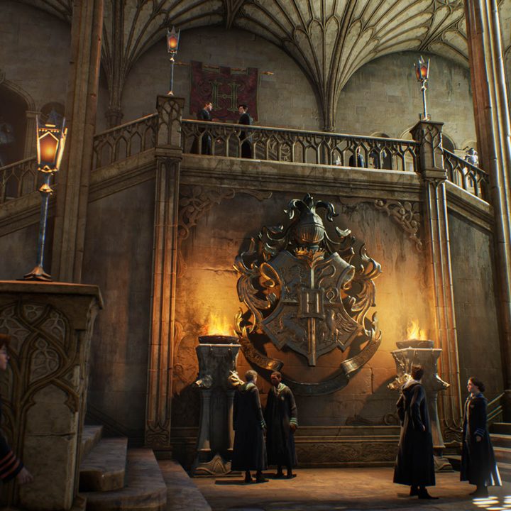 Students stand around a lobby in Hogwarts Legacy.