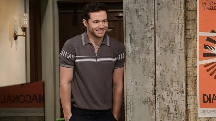 Charlie standing at a doorway, hands in his pockets smiling in a scene from How I Met Your Father.