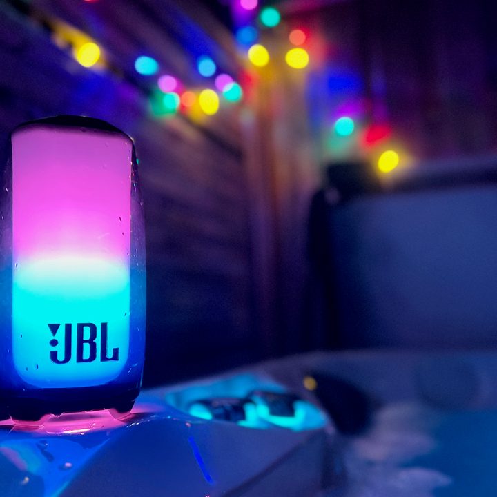 The LBL Pulse 5 Bluetooth speaker sitting on a hot tub ledge.