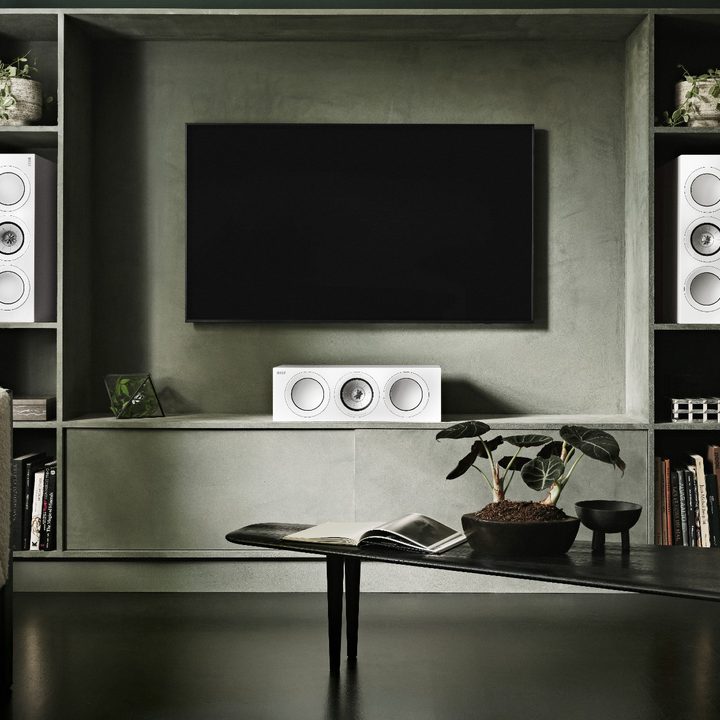 MBARGOED till Feb. 7, 2023. -- The KEF R2 Meta center speakers in a left-center-right configuration with a TV.