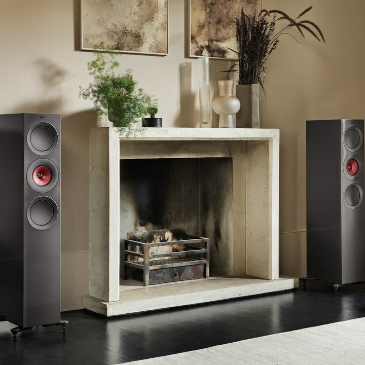 EMBARGOED till Feb. 7, 2023. -- The KEF R7 Meta tower speakers beside a fireplace.