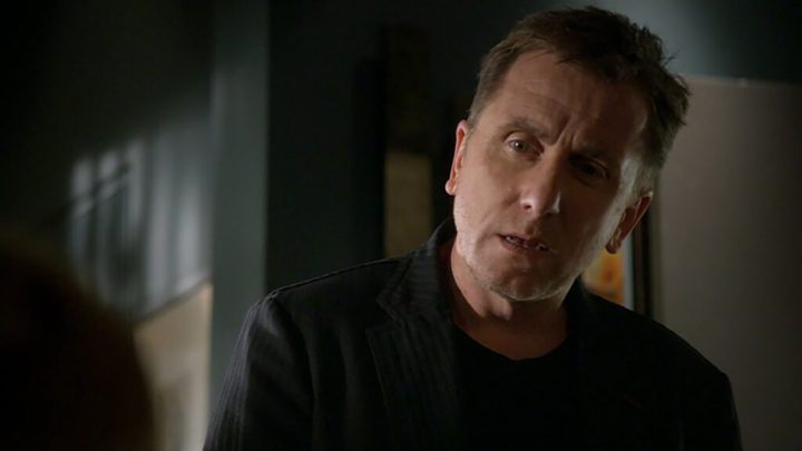 The lead character in Lie to Me, head cocked to the side talking to someone.