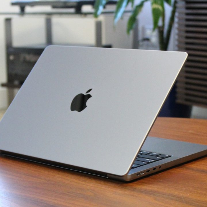The MacBook Pro on a wooden table.