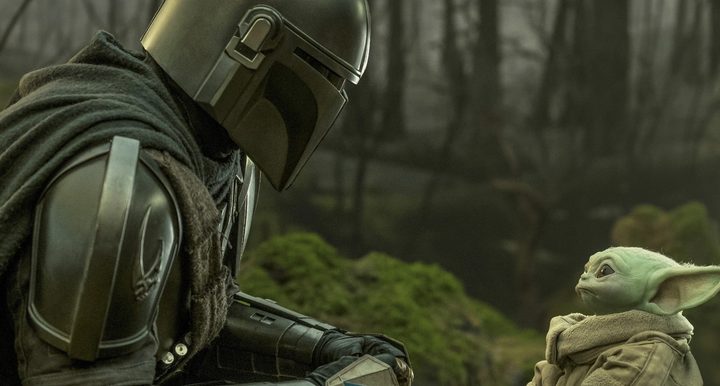 The Mandalorian looks at Grogu in The Book of Boba Fett.