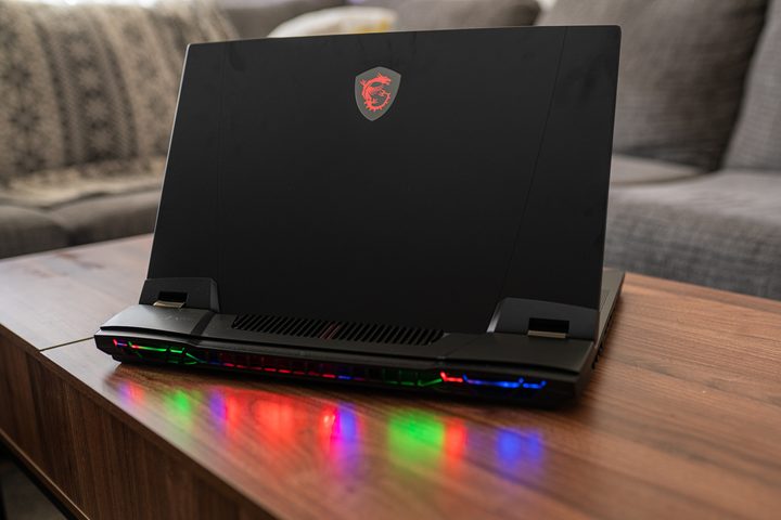 The back of the MSI GT77 Titan (2023) while sitting on a coffee table.