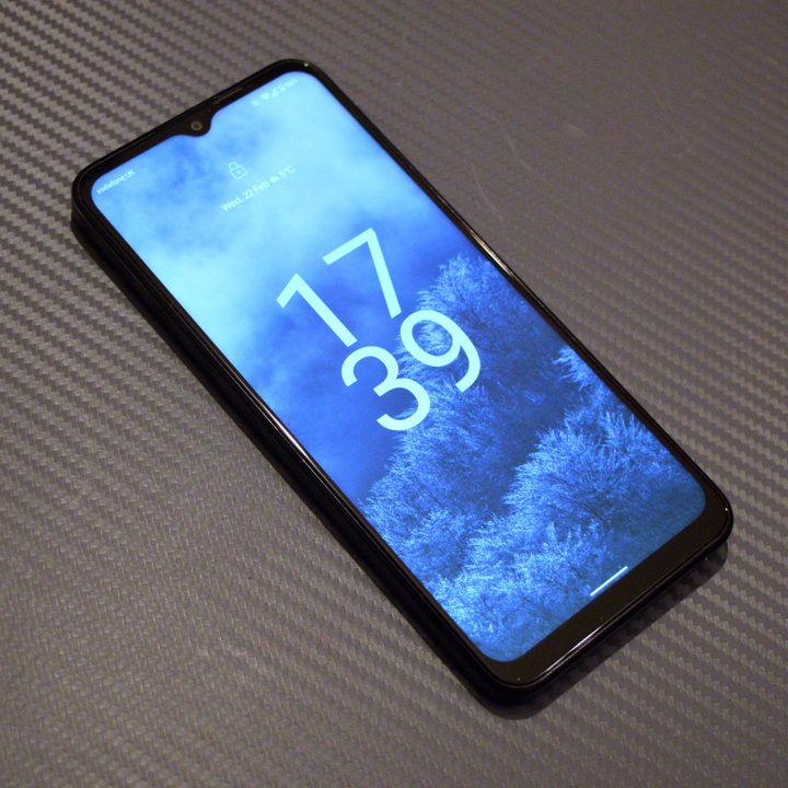 The Nokia G60 5G laid on a lapdesk with the screen on.